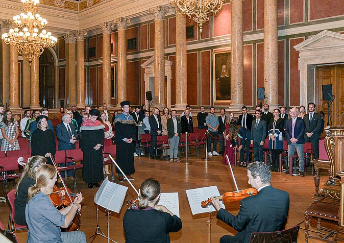 graduates, family, friends at the ceremonial hall accompanied by String Quartet